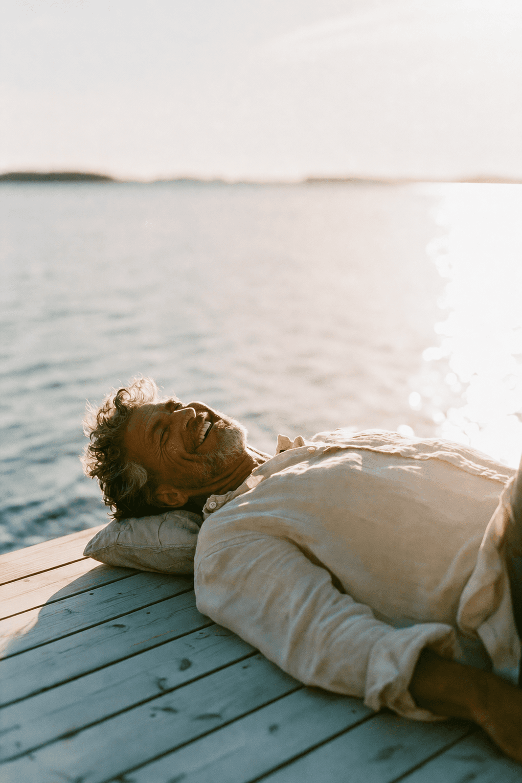 Teledris patient relaxing on a wooden dock by a sparkling lake